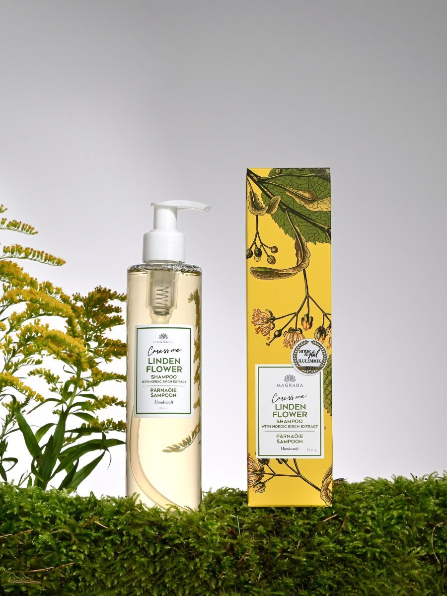 Lindblomsschampo med nordiskt björkextrakt i genomskinlig flaska med pump och gul förpackning med botaniska motiv