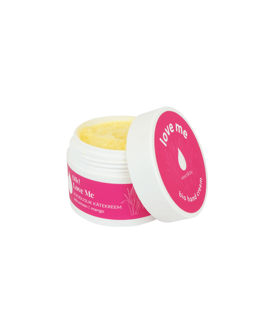 Öppen burk handkräm torra händer med mango, gul kräm synlig, rosa lock med texten love me