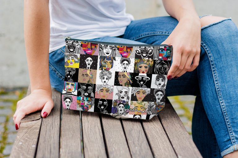 Makeup bag med färgglatt mosaik-motiv av ansikten i pop art-stil, kvinna i jeans sitter på träbrygga