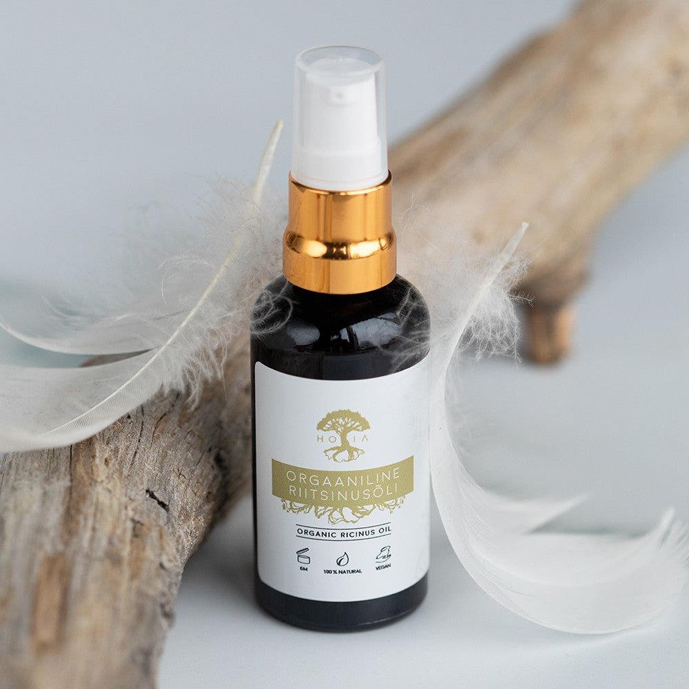 Naturlig Ricinolja 50ml i mörk glasflaska med vit etikett, guldmetallic pumpspray och vit kåpa
