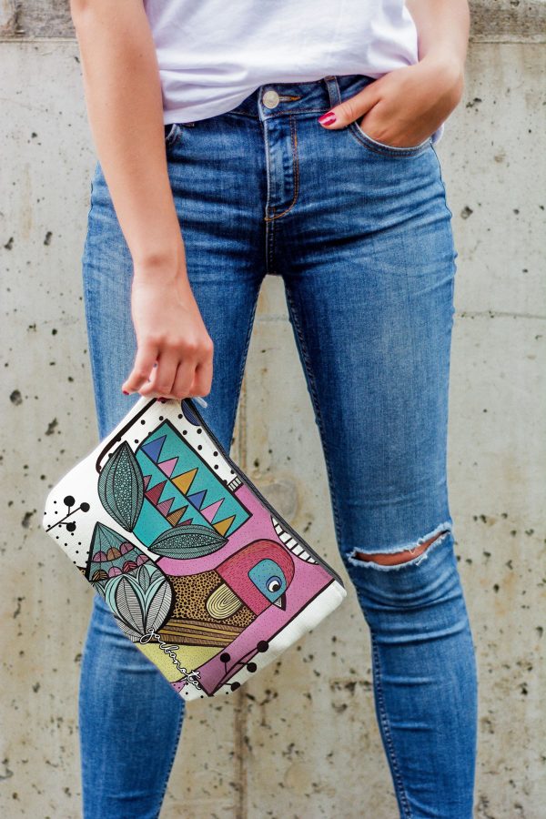 Makeup Bag Little Bird - färgglad necessär med fågelmotiv i rosa, grönt och geometriska mönster hålls i hand