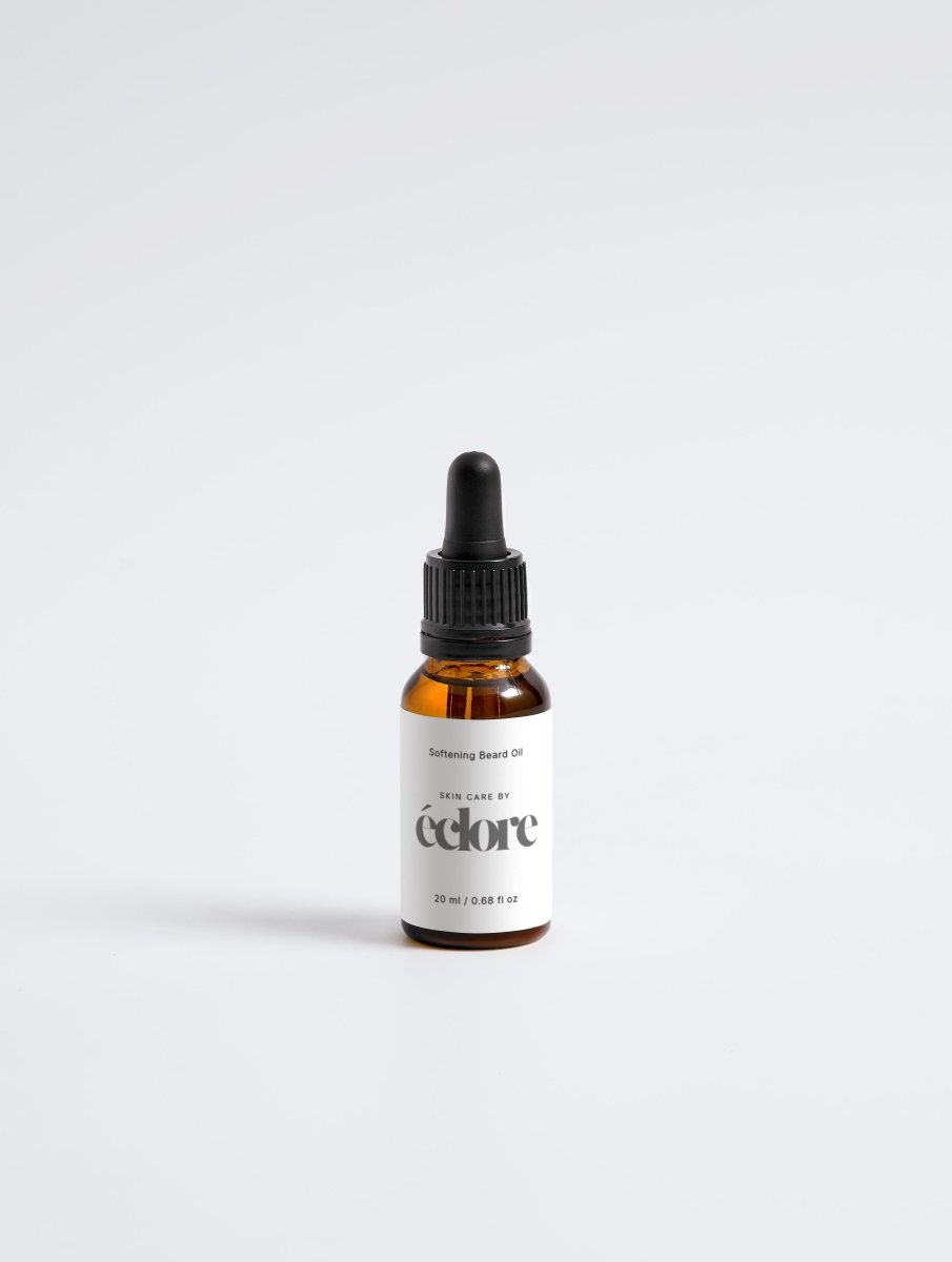 Softening Beard Oil i amber glasflaska med svart pipett, vit etikett med éclore-logotyp, 20 ml