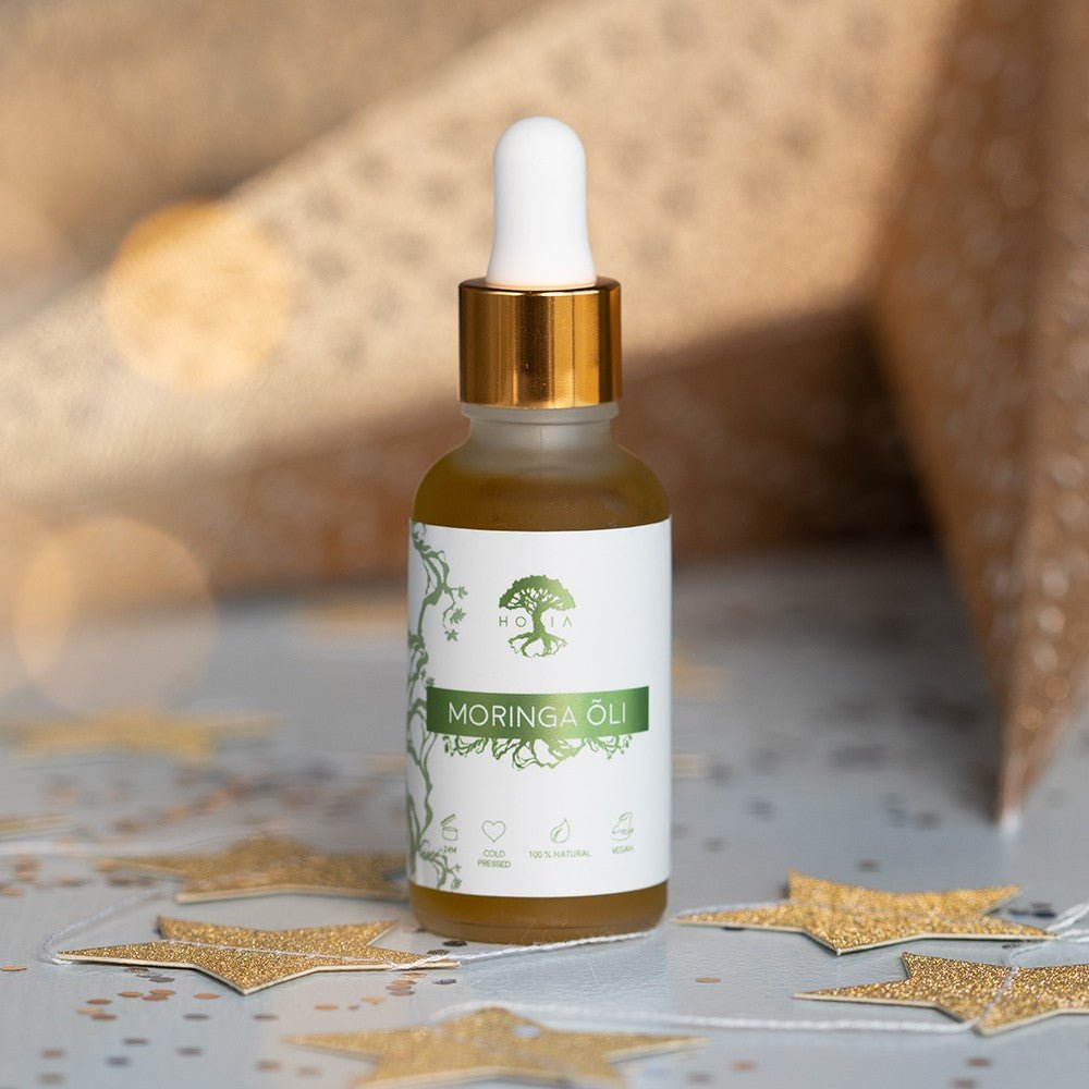 Ekologisk Moringa Olja 30ml i glasbehållare med guldlock och pipett, vit etikett med grönt tryck på marmorbakgrund