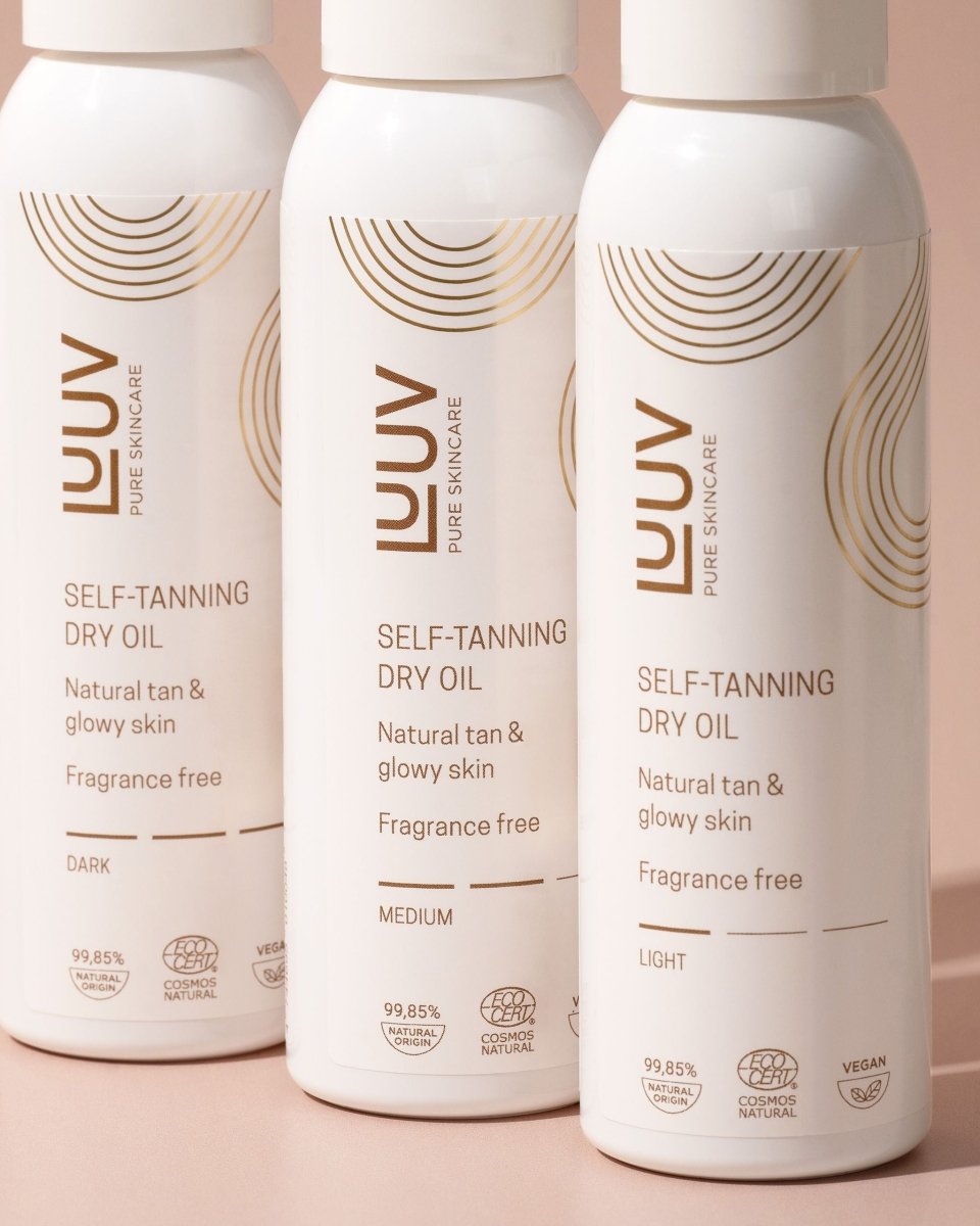 Luuv Pure Skincare Self-Tanning Dry Oil i vit sprayflaske med guldiga detaljer, visar Dark-varianten för mörk brun utan sol