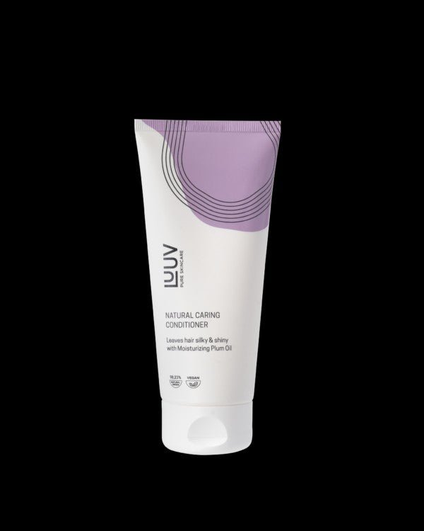 Vit tub med lila designelement innehåller Närande Balsam med Plommonolja 200ml, reparerande hårvård med värmeskydd