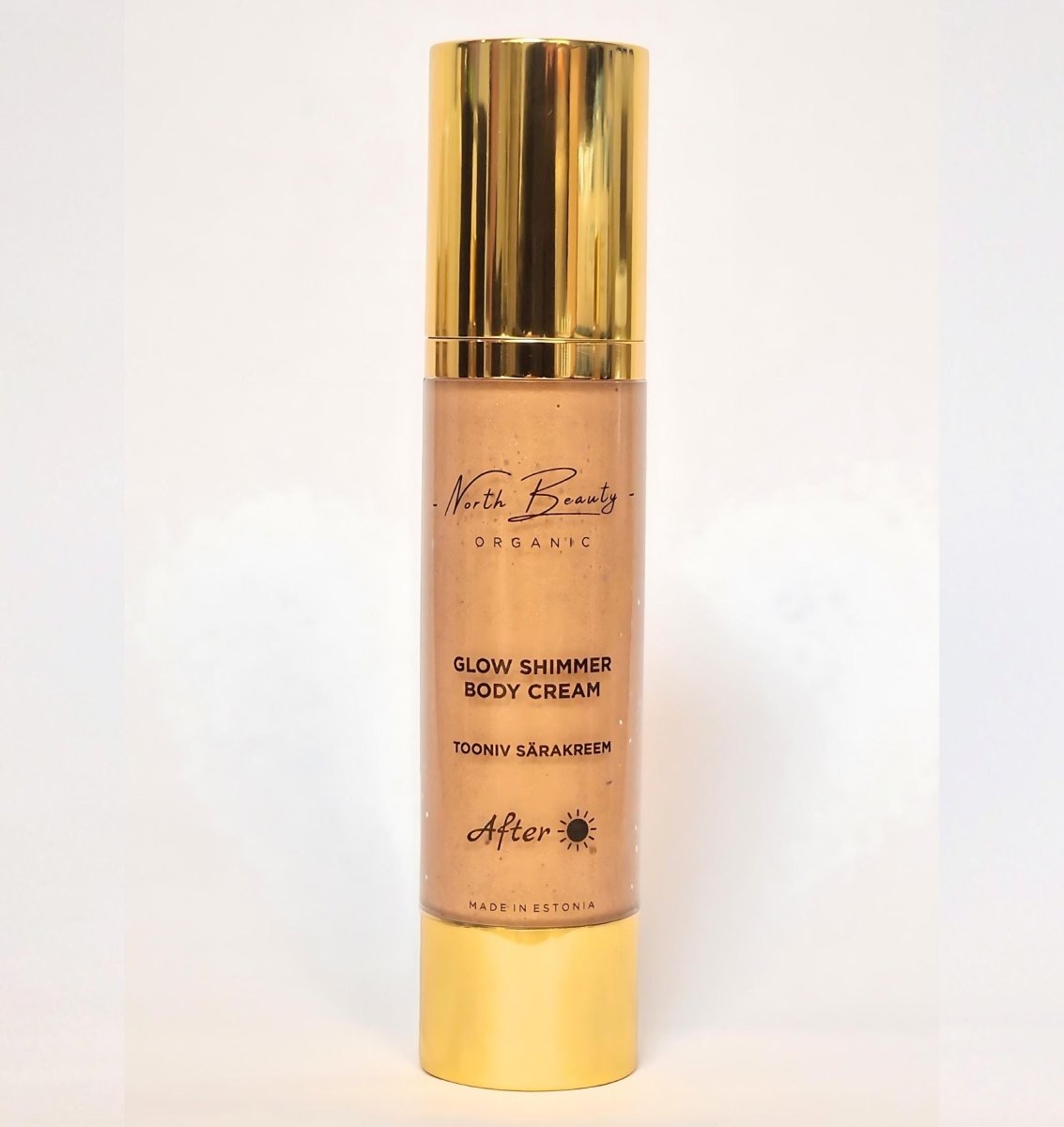 Gyllene pumppump med Tinted Glow Cream i bronsfärgad nyans, elegant glasflaska med guldlock