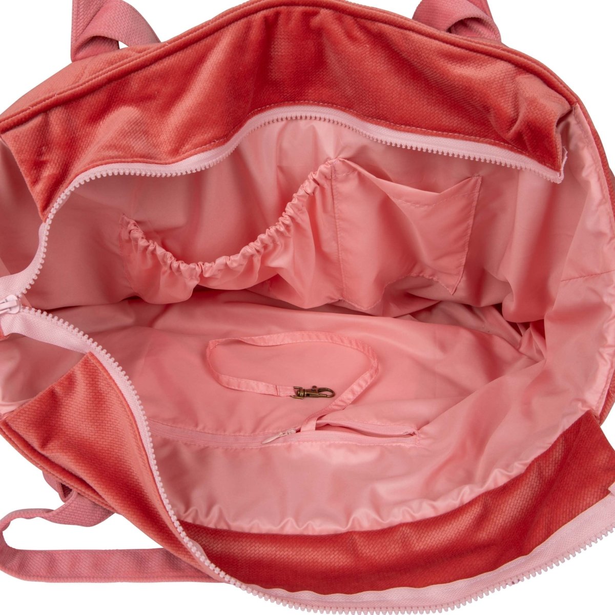 Insida av handgjord weekenderbag i sammet med innerfickor och vattentätt rosa foder